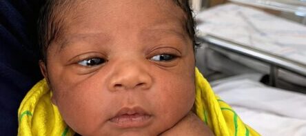 After a decade of heartbreaking losses, we finally welcomed the baby girl we had dreamed of for so long. But the moment the nurse placed her in my husband’s arms, his face went white. He stared at the tiny birthmark on her shoulder and whispered in disbelief, “No… this can’t be real.”